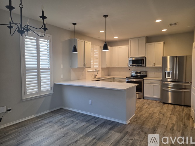 A modern kitchen with stainless steel appliances and a large island.