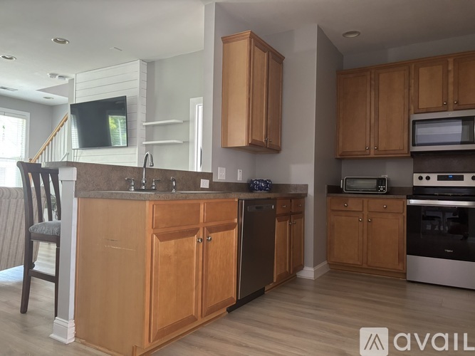A kitchen with wooden cabinets and a granite countertop.