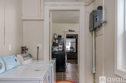 A kitchen with a white counter and a white fridge.