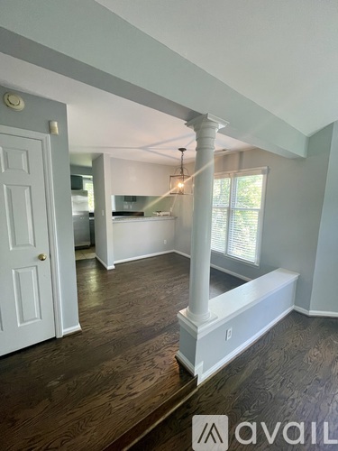 A room with a white door and a window with blinds.