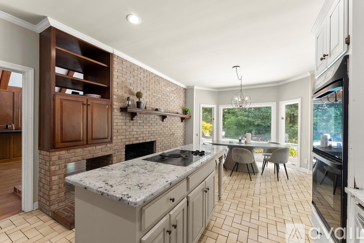 A kitchen with a brick wall and a marble countertop.