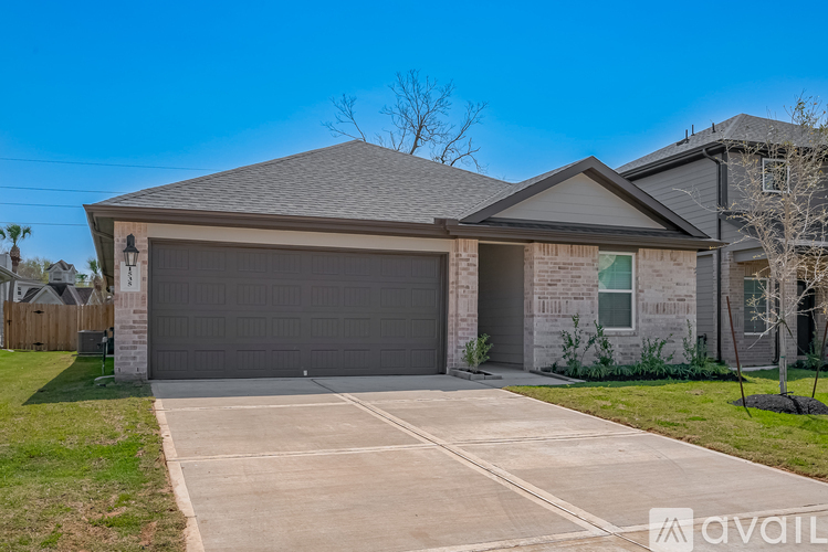 A house with a garage and a driveway in front.
