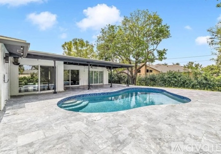A modern house with a pool in the backyard.