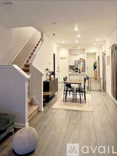 A living room with a dining table and chairs.
