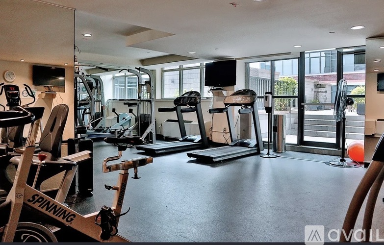 A gym with a Spinning bike in the foreground.