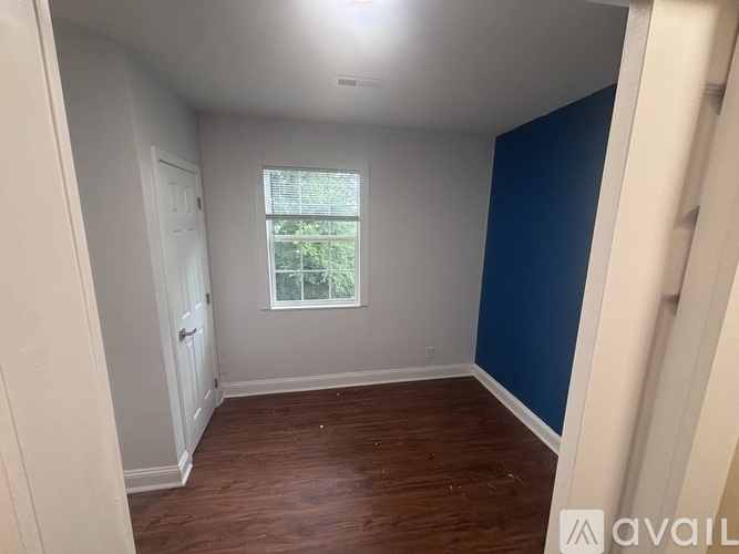 A room with a window and a door.