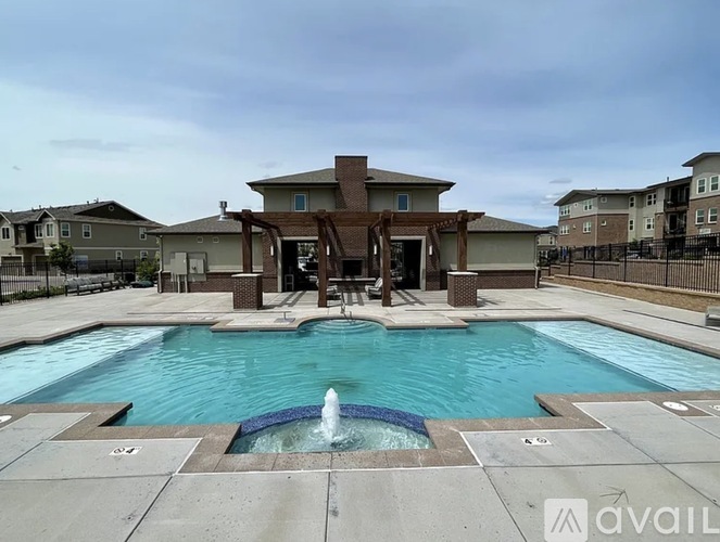 A large swimming pool with a fountain in the middle of it.