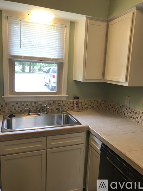 A kitchen with a sink and a window.