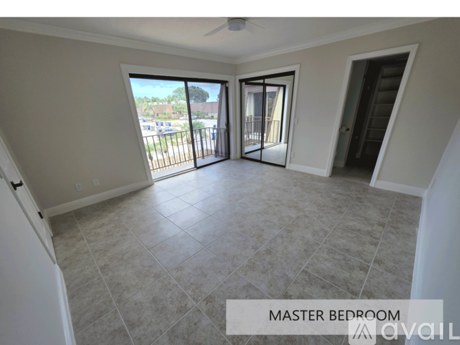 A master bedroom with a sliding glass door leading to a balcony.