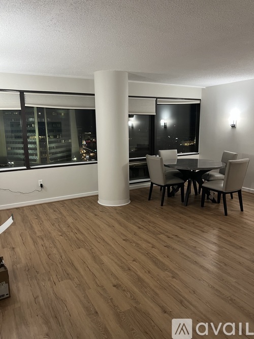 A dining room with a table and chairs.
