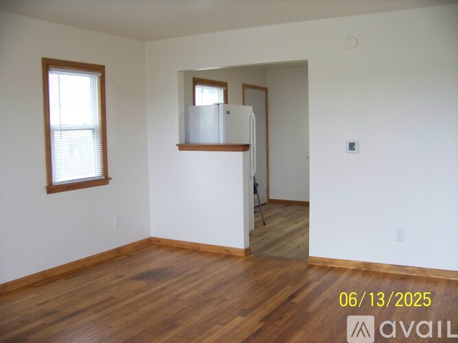 A room with wood flooring and a window is available for rent.