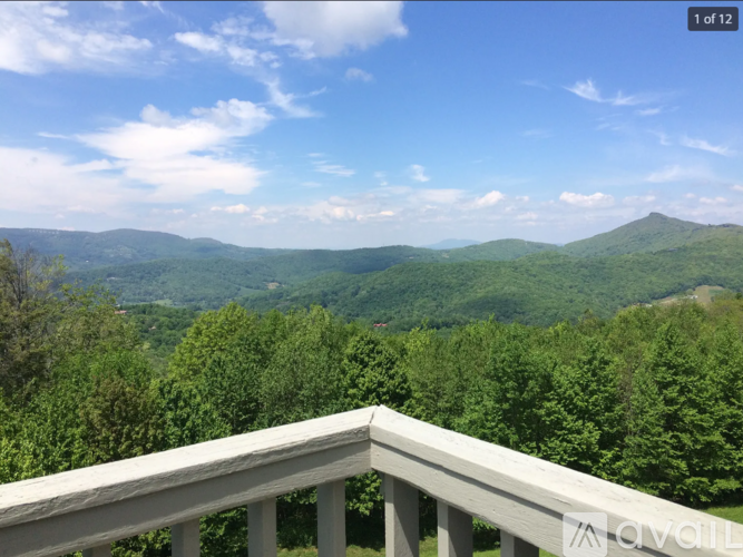 A mountain range is visible from a balcony.