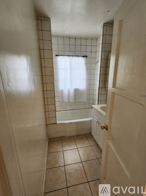 A bathroom with a tiled shower and a bathtub.