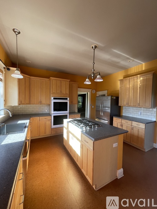 A kitchen with wooden cabinets and a central island.