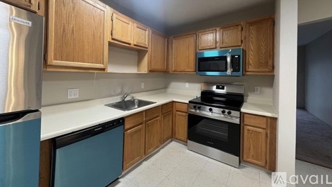 A kitchen with wooden cabinets and stainless steel appliances.