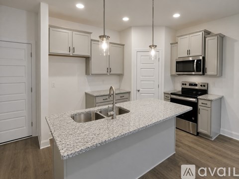 A kitchen with granite countertops and stainless steel appliances.