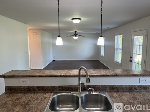 A kitchen with a sink and a fan.