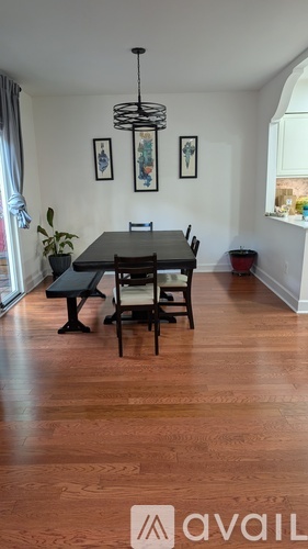 A dining room with a table and chairs.