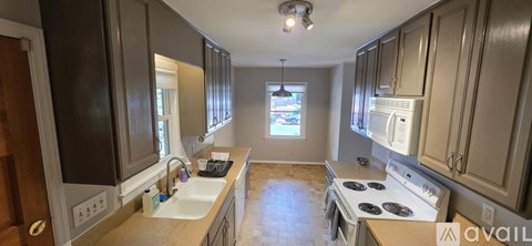 A kitchen with a stove top oven and a sink.