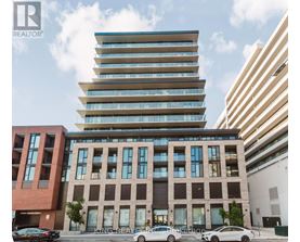 A modern multi-story building with a glass facade is the focal point of the image.