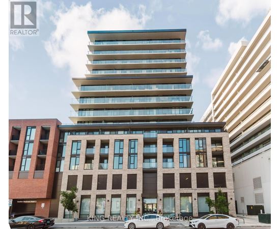 A modern multi-story building with a glass facade is the focal point of the image.