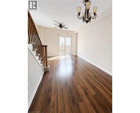 A room with wooden floors and a chandelier.