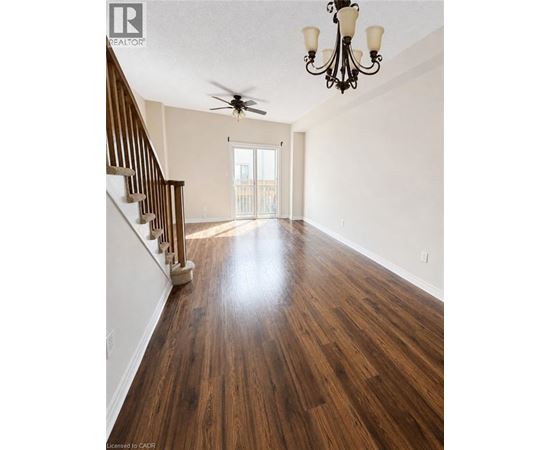 A room with wooden floors and a chandelier.