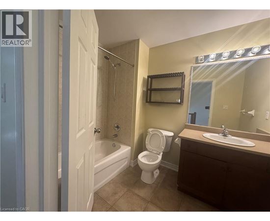A bathroom with a toilet, sink, and bathtub.