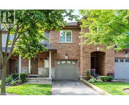 A house with a brick facade and a grey garage door.