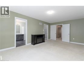 A spacious living room with a fireplace and built-in cabinets.