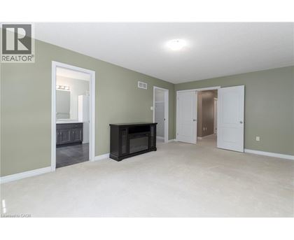 A spacious living room with a fireplace and built-in cabinets.