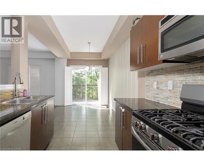 A kitchen with a black stove top oven and a microwave above it.
