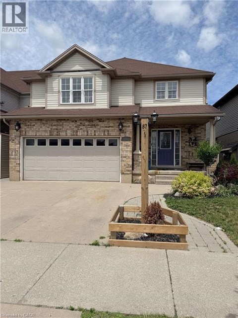 A house with a brown garage door and a brown roof.