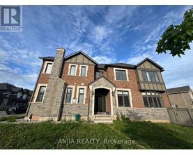 A large brick house with a stone chimney is for sale.