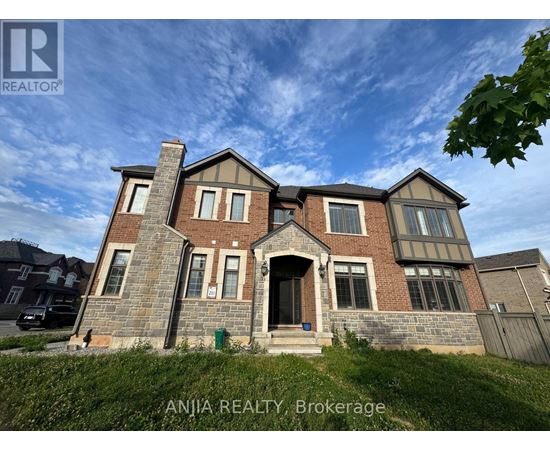 A large brick house with a stone chimney is for sale.