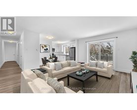 A living room with a couch, coffee table, and a large window.