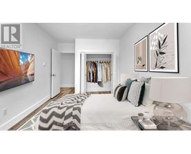 A bedroom with a large bed and a wardrobe.