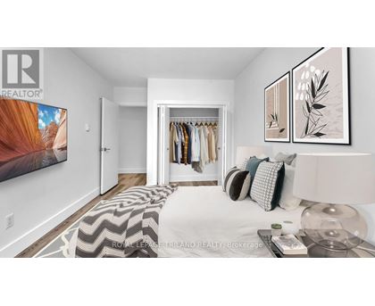 A bedroom with a large bed and a wardrobe.