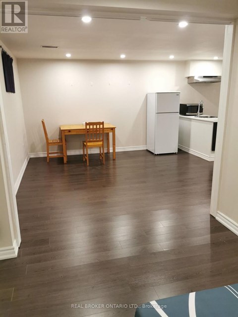 A dining room with a table and chairs.