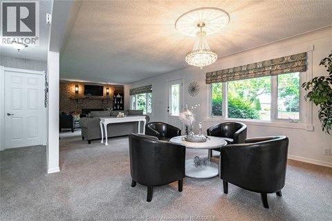 A living room with a dining table and chairs.