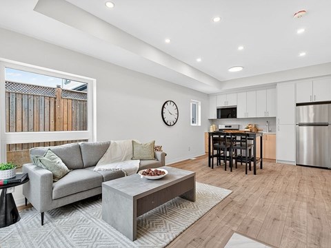 A modern living room with a grey sofa and a coffee table.