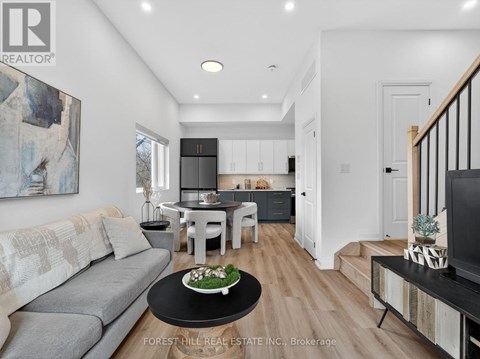 A modern living room with a grey sofa and a black coffee table.