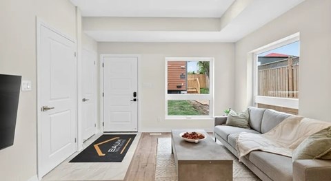 A living room with a grey couch and a coffee table.