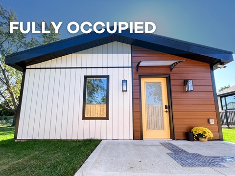 A small house with a brown door and windows is labeled as "Fully Occupied".