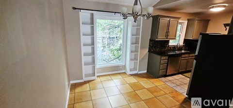 A bedroom with a bed, a wardrobe and a small fridge.
