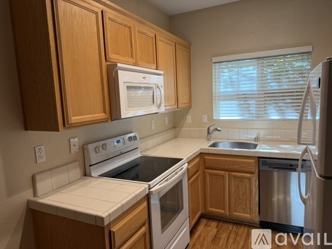 A kitchen with wooden cabinets and stainless steel appliances.