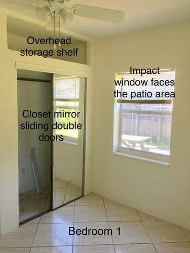 Bedroom 1 has a closet with a mirror and sliding doors.