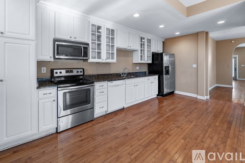 A kitchen with white cabinets and stainless steel appliances.