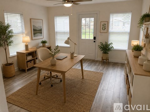 A room with wooden flooring and two windows.