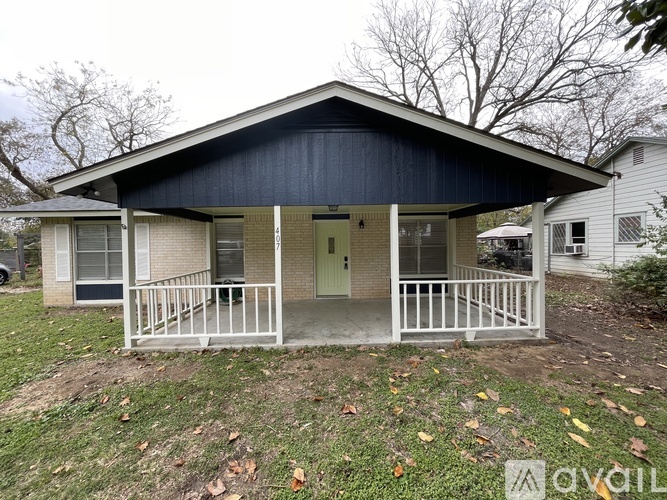 A small house with a porch and a covered entrance.